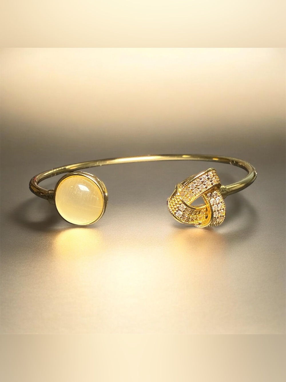 Gold-Tone Open Cuff Bracelet with Yellow Stone and Crystal Knot